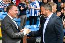 Celtic manager Brendan Rodgers, left, shakes hands with his Kilmarnock counterpart Derek McInnes, right, earlier this season